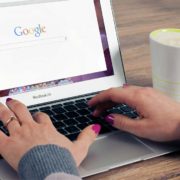 A woman is searching online. Google will list websites with the best on-page SEO.
