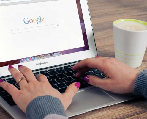 A woman is searching online. Google will list websites with the best on-page SEO.
